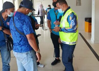 ANGGOTA  polis melakukan pemantauan pematuhan SOP di sebuah bank di bandar lama Lipis di Lipis, Pahang hari ini.
