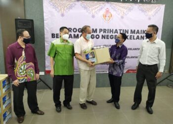 MOHD. AZMAN Ghazali (dua kanan) menyerahkan bantuan Prihatin Maik kepada wakil NGO di Lembah Sireh, Kota Bharu, Kelantan, hari ini. - UTUSAN/ROSALWANI CHE SOH