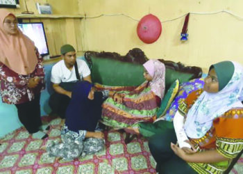 NORIZAN Mat Isa (duduk) dan Mohamad Farhan (baju putih) melihat Nurul A'liah dan Sofia Umaira (duduk) di rumah mereka di Taman Malim Indah, Melaka. - UTUSAN/AMRAN MULUP