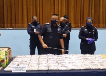 KAMARUL Zaman Mamat menunjukkan sebahagian dadah yang dirampas di tiga buah rumah di IPD Kuala Muda, Sungai Petani, Kedah, hari ini. - UTUSAN/OTHMAN YAHAYA