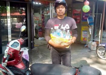 MOHAMAD Halim Hassan menunjukkan air mineral yang diperolehnya di sebuah kedai runcit bagi kegunaan di rumah di Taman Ria Jaya, Sungai Petani. -UTUSAN/OTHMAN YAHAYA