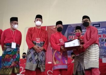 MUHYIDDIN Yassin (tengah) menerima borang keahlian Bersatu Parlimen Pagoh sempena Persidangan Bersatu Bahagian Pagoh kali ke-3 di Dewan Belia Batu 28, Lenga, Muar, di Johor - UTUSAN/NUR ALINA HASSAN