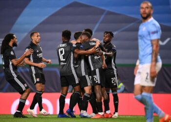 PEMAIN Lyon meraikan jaringan Moussa Dembele ketika menumpaskan Manchester City 3-1 dalam suku akhir Liga Juara-Juara di Lisbon, awal pagi tadi. - AFP