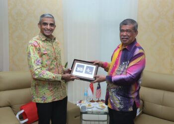 Pesuruhjaya Tinggi Singapura ke Malaysia, Vanu Gopala Menon (kiri) menerima cenderahati daripada Mohamad Sabu selepas melakukan kunjungan hormat ke Menara Lembaga Pertubuhan Peladang (LPP), baru-baru ini.