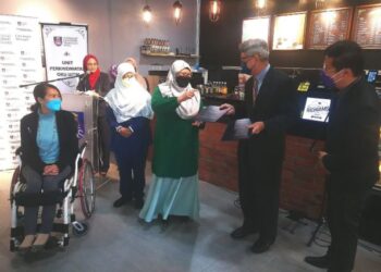 RAS Adiba Radzi (kiri) menyaksikan pertukaran MoU antara Roziah (tiga dari kiri) dan Abu Hassan (dua dari kiri) di Richiamo Coffee UiTM Puncak Alam, Selangor, hari ini. - FOTO/ABDUL RAZAK IDRIS