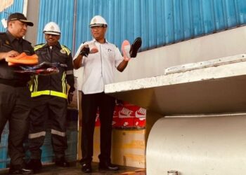 AZMAN Mohd. Yusof (kanan) menunjukkan barang rampasan yang dilupuskan pada Majlis Pelupusan Ekshibit Mega Tahun 2022 dan Majlis Serah Terima Stesen Alat Timbang Kenderaan (ATK) KPDNHEP di Kompleks Penyimpanan Ekshibit Bahagian Penguat kuasa KPDNHEP di Nilai, Seremban hari ini. - FOTO/AFIFI HAFIZ MOHD. NOR