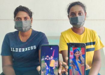 R. Thammamty (kanan) dan adiknya, R. Turgadevi menunjukkan gambar tiga sepupu mereka yang meninggal dunia dalam kejadian lemas di Pantai Cahaya, Port Dickson, Negeri Sembilan. - UTUSAN/NOR AINNA HAMZAH