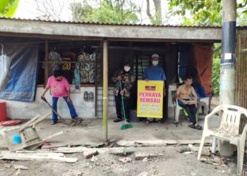 SUKARELAWAN Perkaya membersihkan rumah Osman dari kekotoran najis ayam di Kampung Rendah, Pedas, Rembau hari ini.-UTUSAN/NOR AINNA HAMZAH