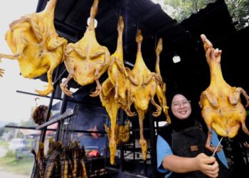 NORAFAZREEN Kamarulzaman menunjukkan itik salai yang dijual digerainya di Kampung Terachi, Kuala Pilah ketika ditemui Utusan Malaysia, semalam.-UTUSAN/MOHD SHAHJEHAN MAAMIN.