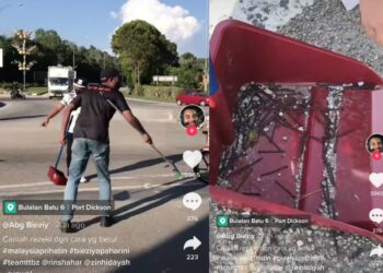TANGKAP layar video tular memaparkan sekumpulan pemuda membersihkan ratusan paku berkarat yang bertaburan di Bulatan Batu 6, Bandar Sunggala, Port Dickson, Negeri Sembilan, semalam. - MEDIA SOSIAL