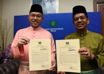 AZLAN Man (kiri) menunjukkan watikah pengisytiharan pembubaran DUN Perlis di Kompleks DUN, Kangar, Perlis hari ini.- UTUSAN/IZLIZAN OTHMAN