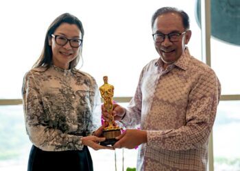 MIchelle Yeoh menunjukkan anugerah Pelakon Wanita Terbaik Oscak yang diterimanya kepada Anwar Ibrahim ketika mengunjungi Perdana Putra, Putrajaya, semalam..