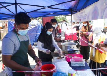 NUR Dalila Abdul Manab (kanan) sedang menyiapkan pesanan pelanggan yang  beratur dihadapan gerai mereka yang terletak berhampiran Pejabat Telekom cawangan Kepala Batas. UTUSAN/ MOHAMMAD FIRDAUS AMRAN