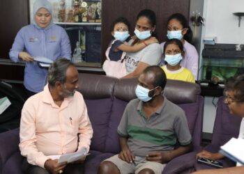 V. SIVAKUMAR menerangkan dokumen penerimaan Faedah Pencen Ilat dan bantuan Perkeso kepada K. Gunasegaran ketika mengunjungi rumah penerima itu di Klang, Selangor, semalam. – UTUSAN/AFIQ RAZALI