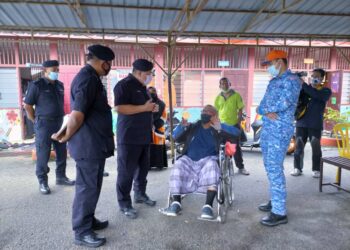 ROSLEE Chik (dua kiri) berbual dengan salah seorang mangsa banjir di Sekolah Kebangsaan Bukit Mentok di Kemaman hari ini. - UTUSAN/NIK NUR IZZATUL HAZWANI NIK ADNAN