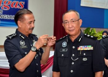 RAZARUDIN Husain (kiri) memakaikan pangkat kepada Omar Bakhtiar Yaacob pada majlis Serah Terima Tugas Ketua Polis Daerah Kuala Kangsar di Kuala Kangsar, Perak hari ini. - FOTO/ZULFACHRI ZULKIFLI