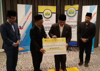 TUANKU Syed Faizuddin Putra Jamalullail (dua dari kanan) menerima replika cek zakat perniagaan sebanyak RM945,934.00 sumbangan RCB di Kuala Lumpur, hari ini.