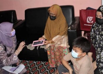 RINA Mohd. Harun (kiri) menyampaikan sumbangan kepada Faridah ketika melawat keluarga lima beradik berkenaan di Bandar Sunggala, Port Dickson, hari ini.-UTUSAN/NOR AINNA HAMZAH.