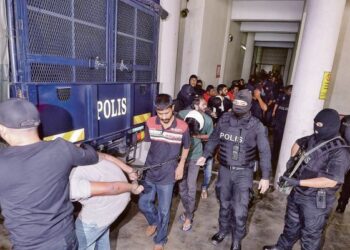 Petugas sTAFOC Bukit Aman berkawal mengiringi kesemua tertuduh selepas didakwa menjadi ahli kumpulan jenayah terancang Geng 08 di Mahkamah Tinggi Kuala Lumpur pada 23 April lalu.-GAMBAR HIASAN