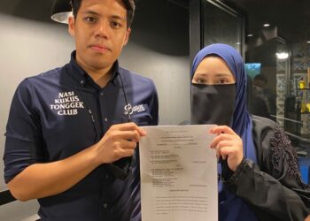 MUHAMMAD Nur Aiman Basuni (kiri) dan Siti Nabilah Mohamad Isa menunjukkan penyata tuntutan terhadap dua defendan.