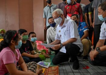 ISMAIL SABRI YAAKOB beramah mesra dengan kanak-kanak mangsa banjir yang menghuni Pusat Pemindahan Sementara (PPS) Kampung Batu 23, Hulu Terengganu, Mac lalu. – UTUSAN/PUQTRA HAIRRY