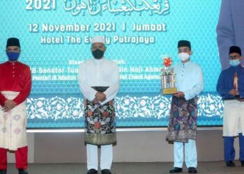 IDRIS Ahmad menyampaikan hadiah Johan Majlis Ihtifal Ilmi Sekolah Menengah Agama Malaysia (MIISMAM) kategori Syarahan Bahasa Melayu kepada Muhammad Naufal Hakimi Mohd. Rushdi (dua kanan) pada Majlis Penyampaian Hadiah IKK dan MIISMAM Peringkat Kebangsaan 2021. - UTUSAN/FAISOL MUSTAFA