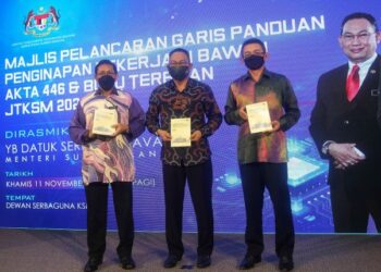 AWANG Hashim (tengah) menunjukkan buku panduan penginapan pekerja (Akta 446) dan Buku Terbitan JTKSM 2021 di Kementerian Sumber Manusia, Putrajaya. - UTUSAN/FAISOL MUSTAFA