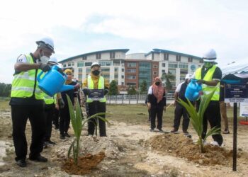 SYED Abu Hussin Hafiz Syed Abdul Fasal (kiri) menyempurnakan gimik menyiram pokok sebagai simbolik pecah tanah tapak pembinaan Kuarters LKIM pada pra pelancaran sambutan Jubli Emas 50 Tahun LKIM di Puchong, Selangor. - UTUSAN/FAISOL MUSTAFA