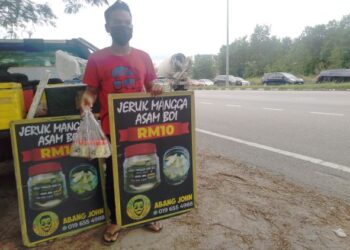 MUHD. AIDIL MUSTAQIM Zulkifli akur dengan arahan pihak berkuasa dan memilih lokasi yang lebih selamat untuk melakukan aktiviti jual beli jeruk mangga. - UTUSAN/MUHAMMAD SHAHIZAM TAZALI