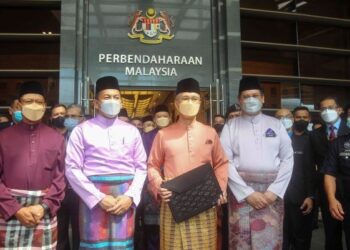 TENGKU Zafrul Tengku Abdul Aziz menunjukkan beg berisi buku laporan Belanjawan 2022 ketika keluar dari Kompleks Kementerian Kewangan menuju ke Bangunan Parlimen bagi membentangkan Belanjawan 2021. - UTUSAN/FAISOL MUSTAFA