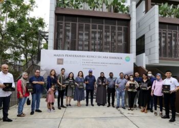 REEZAL Merican Naina Merican (tengah) bergambar dengan pemilik kediaman The Mulia Residences selepas menyerahkan kunci di Cyberjaya. - UTUSAN/FAISOL MUSTAFA