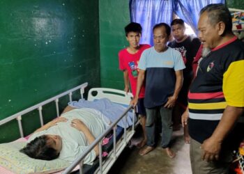KARIM Zainal (tengah) dan Nasarudin Ibrahim (kanan) melihat Mohamad Faizal yang kini terlantar di Taman Pedas Indah, Rembau, Negeri Sembilan, baru-baru ini. - UTUSAN/NOR AINNA HAMZAH