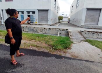 MOHD RADI menunjukkan lokasi lorong-lorong bangunan kedai yang terpaksa dijadikan tempat aktiviti dan permainan selepas penduduk khususnya kanak-kanak tidak mempunyai lokasi yang sesuai.-