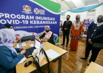 SABARIAH Ramli (duduk tengah) berbual bersama kakitangan Hospital Putrajaya pada majlis penyerahan khemah dilengkapi pendingin hawa di PPV, Hospital Putrajaya. - UTUSAN/FAISOL MUSTAFA