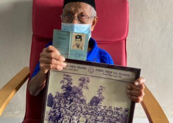 ABDUL RAHAMAN Bakar menunjukkan buku rekod dan gambar kenangannya semasa menjadi anggota polis hutan yang pernah bertempur dengan komunis, di Kepala Batas, Pulau Pinang.