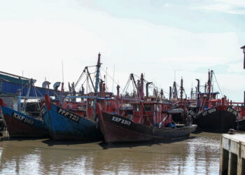 Deretan bot-bot nelayan yang tersadai berikutan ketiadaan awak-awak warga asing di jeti nelayan Kuala Kedah. - UTUSAN/SHAHIR NOORDIN