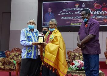 G. Pongavanam (kiri) menyampaikan cenderahati kepada Ismail Abd. Muttalib pada sambutan Hari Deepavali Peringkat Parlimen Maran di Dewan Jubli Perak Sultan Haji Ahmad Shah di Maran hari ini.