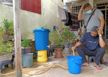 DUA penduduk termenung sambil menunggu bekalan air di Kawasan Perumahan Cina, Taman Rantau Jaya hari ini. - UTUSAN/YATIMIN ABDULLAH
