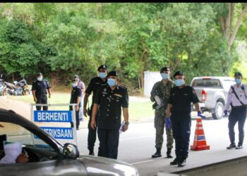 ANGGOTA polis dan ATM melakukan sekatan jalan raya bagi memastikan pematuhan SOP dan sekatan rentas daerah serta negeri. - UTUSAN/FAISOL MUSTAFA