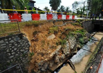 PENDUDUK risau dengan keadaan tebing yang runtuh dan masih belum dibaiki di Jalan Ketapang 9, Taman Rinting, Pasir Gudang, Johor. -UTUSAN/RAJA JAAFAR ALI