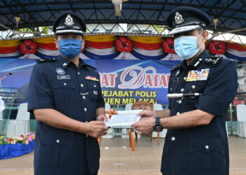 ABDUL MAJID Mohd. Ali (kanan) menyampaikan  sumbangan Op Daulat Tabung Kebajikan Polis Diraja Malaysia kepada Mohamad Hasnal Jamil pada Majlis Sambutan Hari Polis ke-214 di IPK Melaka , Bukit Beruang, Melaka. - UTUSAN/DIYANATUL ATIQAH ZAKARYA
