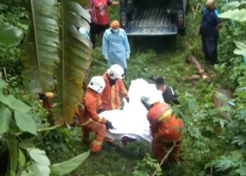 ANGGOTA bomba membantu mengangkat mangsa yang tercampak ke bawah tebing bukit setinggi tiga meter dalam kemalangan di Kilometer 33.3, Jalan Seremban-Simpang Pertang, Jelebu. - UTUSAN/IHSAN POLIS