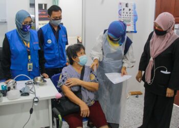 MIMI Mazlin Mohamad Yusof (kanan) bersama seorang penerima vaksin, Ng Yoke Teng yang menerima vaksin di U.n.i  Klinik Forest Heights, Seremban hari ini. Hadir sama, pemilik  U.n.i Klinik Forest Heights, Dr. Nur Syazwani Mohd. Jani.-UTUSAN/MUHAMMAD IZZAT TERMIZIE.