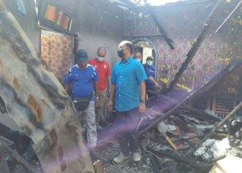 ZAMBRY Abd. Kadir (kanan) meninjau keadaan rumah Amran Bujang yang terbakar malam kelmarin, di Seri Manjung. - UTUSAN/ SHAMSUL KAMAL AMARUDIN