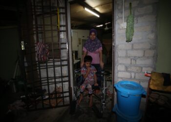 SITI Azura Ariffin bersama anaknya, Muhamad Farez Iqbal yang lumpuh separuh badan di rumah mereka di Kampung Pauh Sayong Hulu dekat Kuala Kangsar. - UTUSAN/ASLIZA MUSA