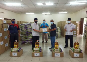 AHMAD Shahir (depan dua dari kiri) menyampaikan sumbangan kepada seorang pemandu bas sambil disaksikan Mohamad Harun (belakang).
