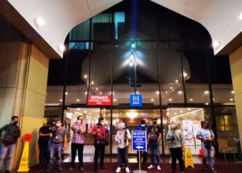 PENGAMAL media berkumpul di lobi Ibu Pejabat UMNO bagi mengetahui perkembangan terkini mesyuarat Majlis Kerja Tertinggi (MKT) UMNO di Menara Dato' Onn, Kuala Lumpur. - UTUSAN/AFIQ RAZALI