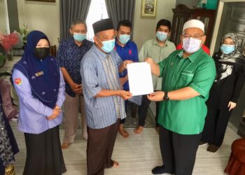 WAN SUKAIRI WAN ABDULLAH (dua dari kanan) menyampaikan bantuan faedah Perkeso kepada Nik Zulkifli Nik Abd. Kadir (tiga dari kiri) di Kampung Gong Tok Nasek di Kuala Terengganu hari ini.