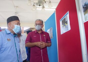 TUAN Ibrahim Tuan Man melihat pelan projek Rancangan Tebatan Banjir bagi daerah Batu Pahat sempena lawatan beliau ke Parit Basri Darat, Sri Medan, Batu Pahat. Gambar: NUR ALINA HASSAN