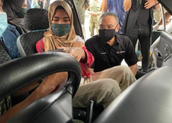 HISHAMMUDDIN Hussein (kanan) melihat proses vaksinasi di PPV pandu lalu di Batalion ke-6 Rejimen Renjer Diraja Kem Ulu Tiram di Johor.